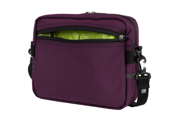 The Side Kick in Aubergine (dark purple) Ballistic with a Kiwi (bright green with white grid) 200 Halcyon interior.